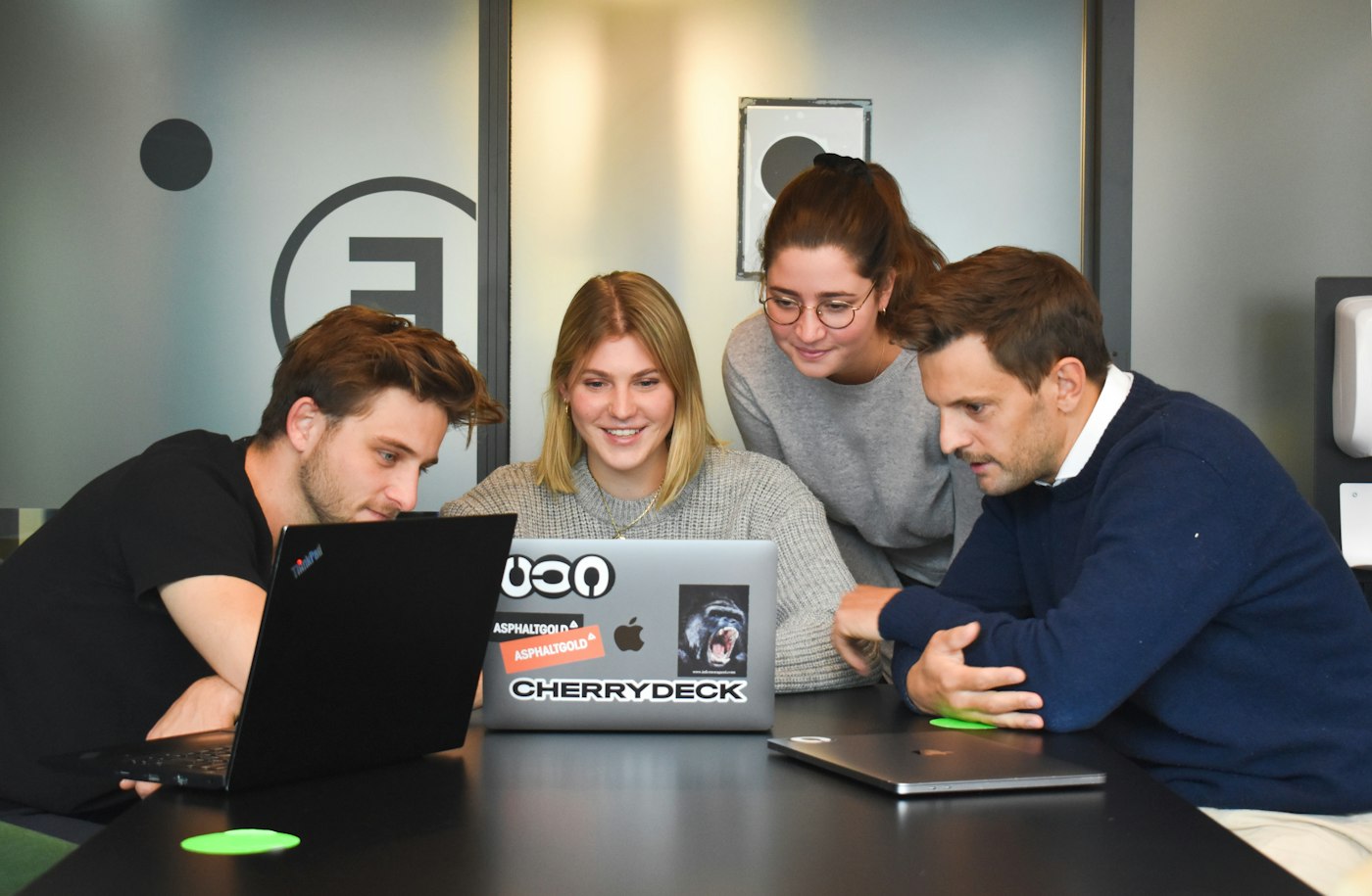 Agency team reviewing work together on a laptop