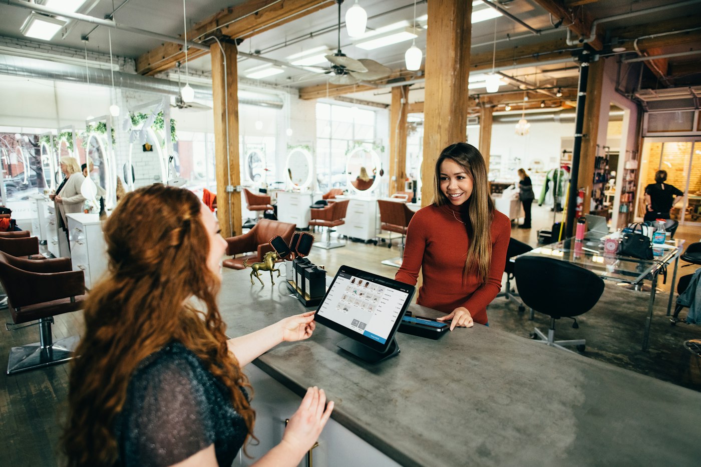 Shop owners helping a customer at the counter